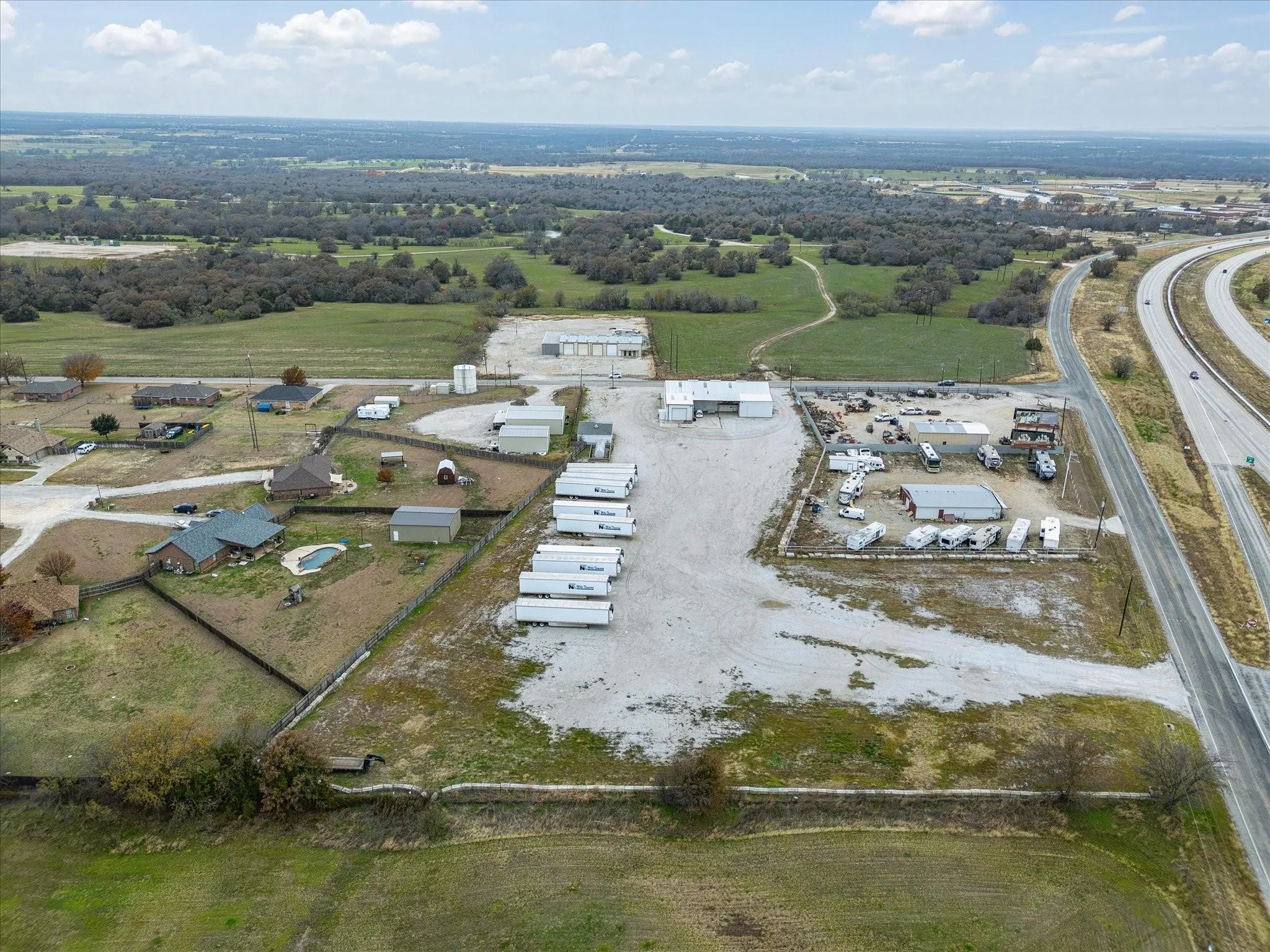 Expansive property featuring commercial buildings and large paved areas