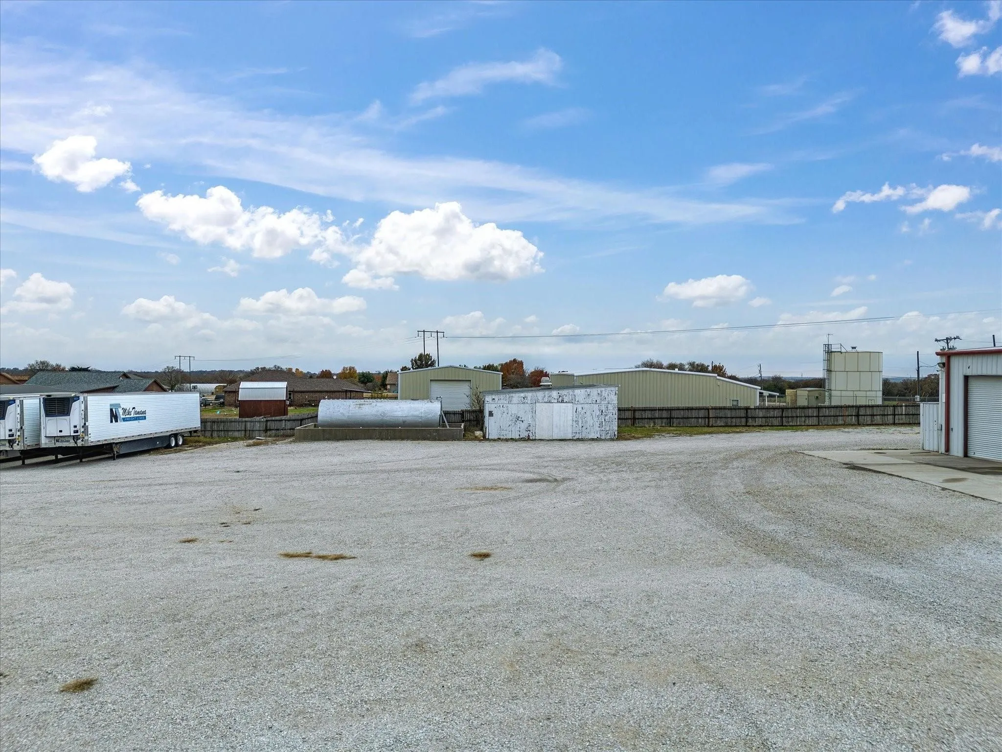 Expansive gravel lot with multiple industrial structures