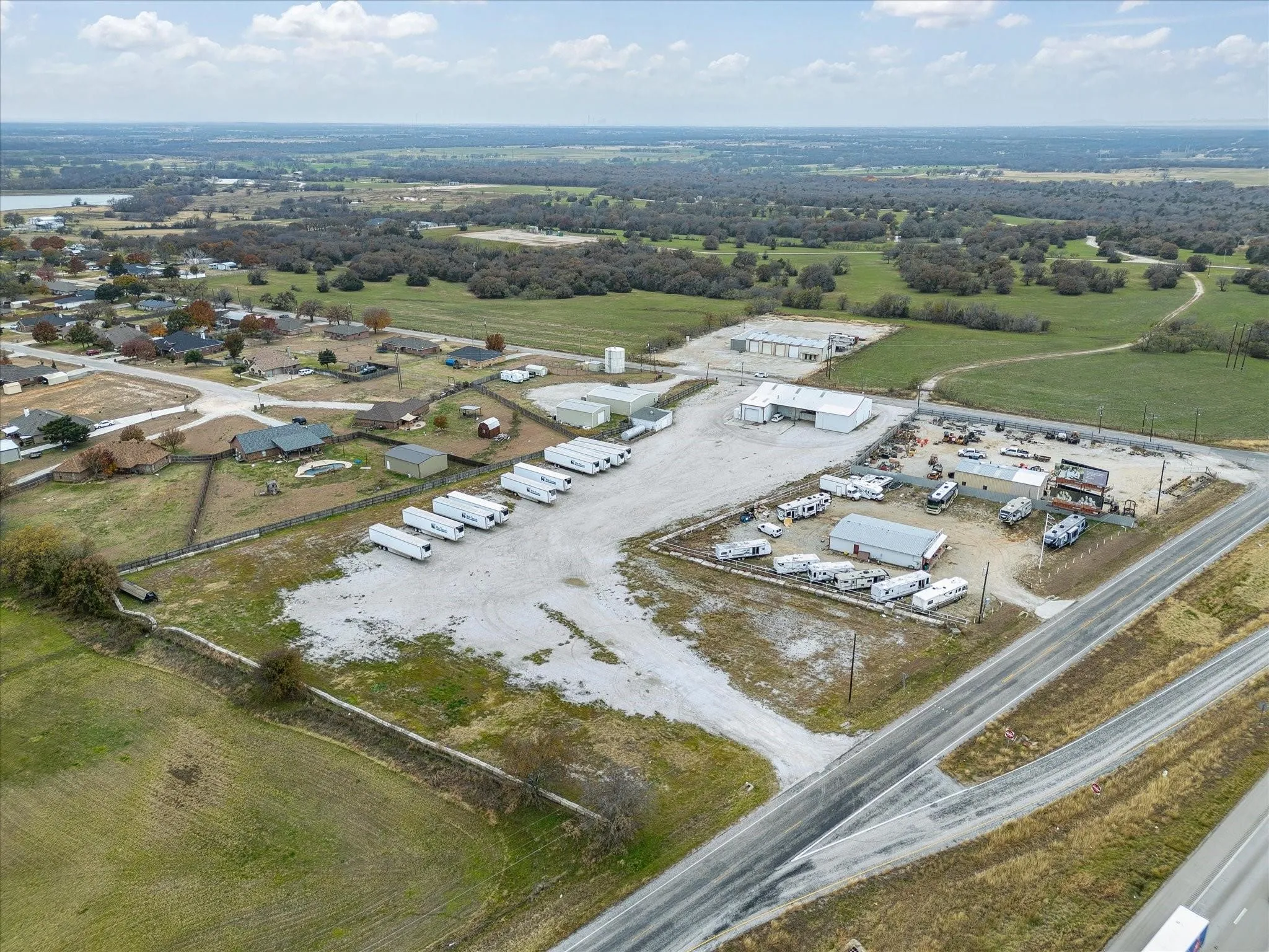 Expansive commercial property featuring multiple structures and direct access to a paved road