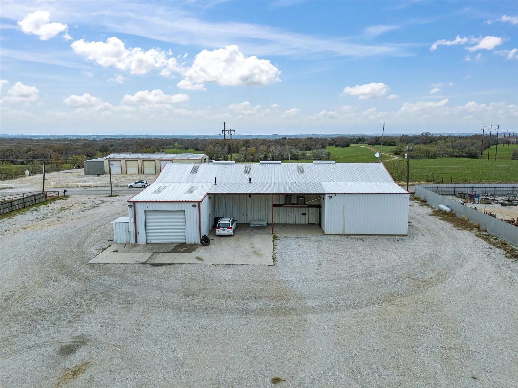 Industrial building with white metal siding and a corrugated metal roof