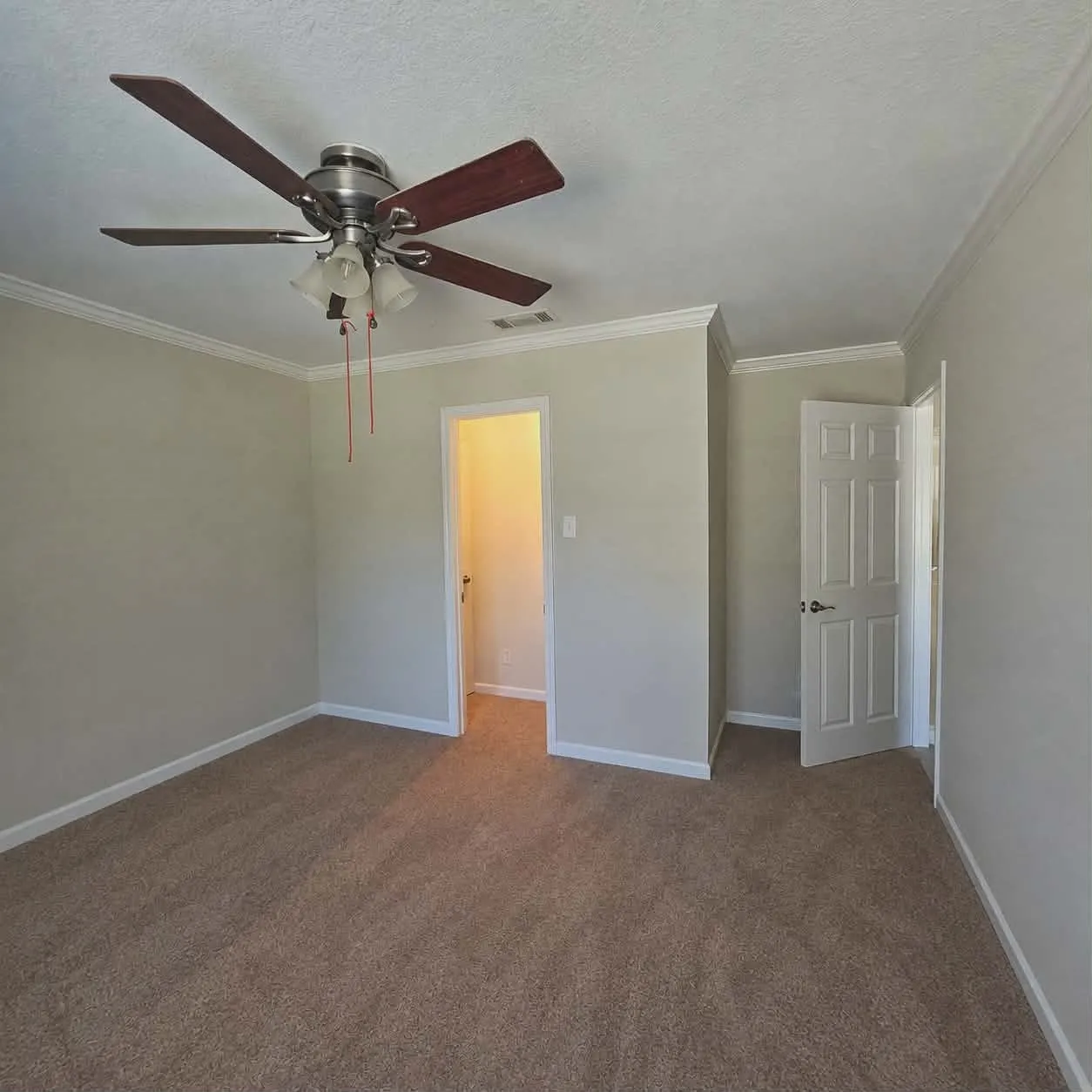 Bedroom 4 -Room featuring textured carpeting, neutral wall paint, and white crown molding-This photo was taken before family moved in