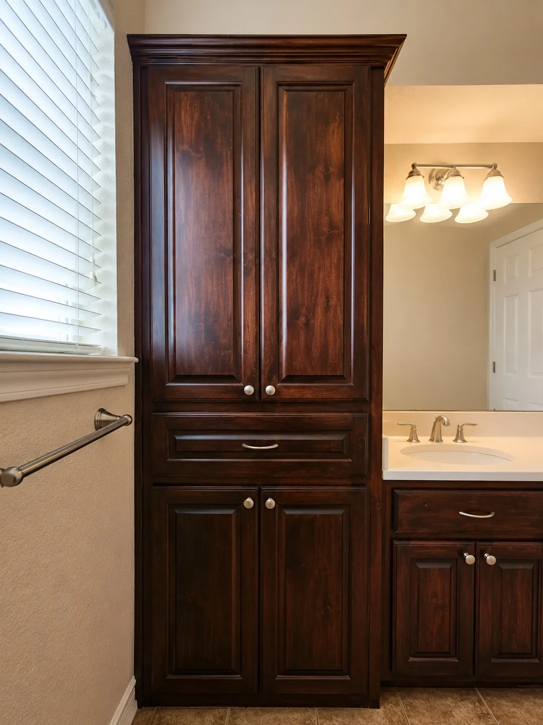 Full second bathroom- all, dark wood-finish cabinetry featuring multiple storage compartments-This photo was taken before family moved in