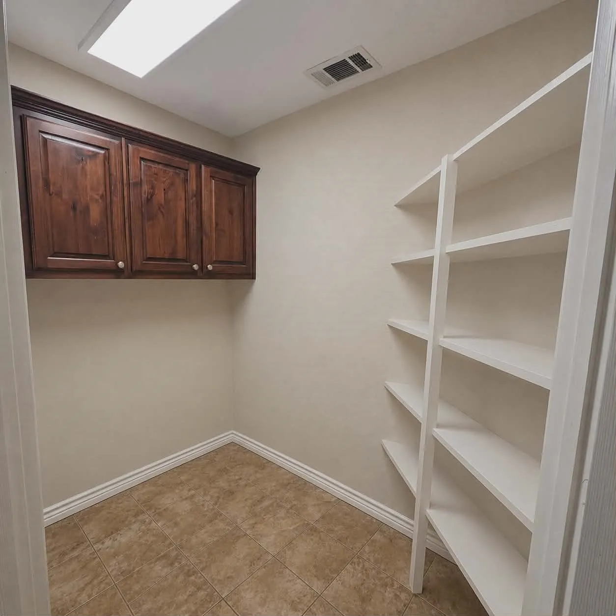 Built-in shelving and cabinetry provide ample storage that may also be used as pantry.-This photo was taken before family moved in