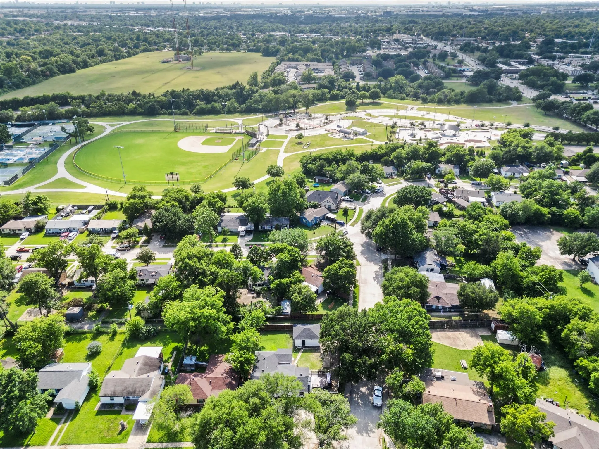 Aerial perspective showcasing a residential area with varied housing styles and mature tree coverage