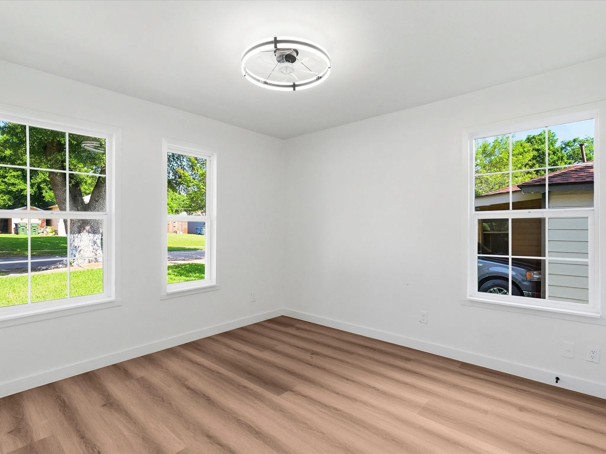 Room featuring wood-finish flooring and white walls