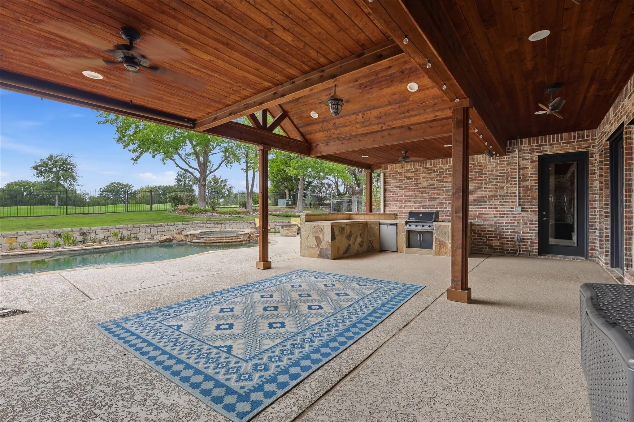 Covered patio featuring wood-finish ceiling, exposed beams, and recessed lighting