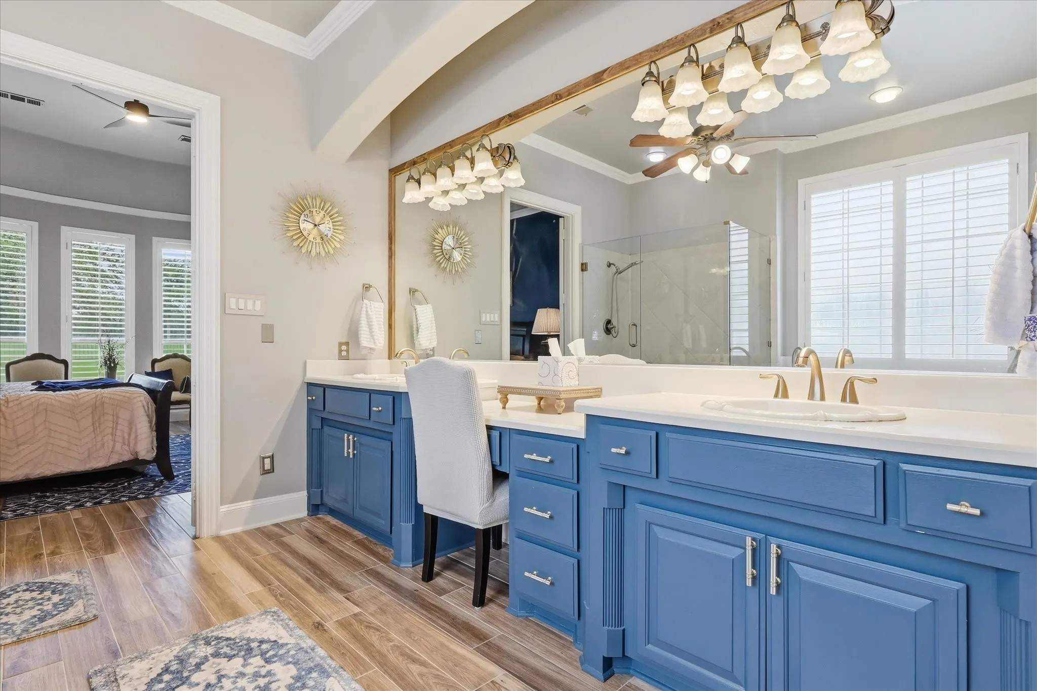Double vanity featuring blue cabinetry, white countertops, and dual sinks