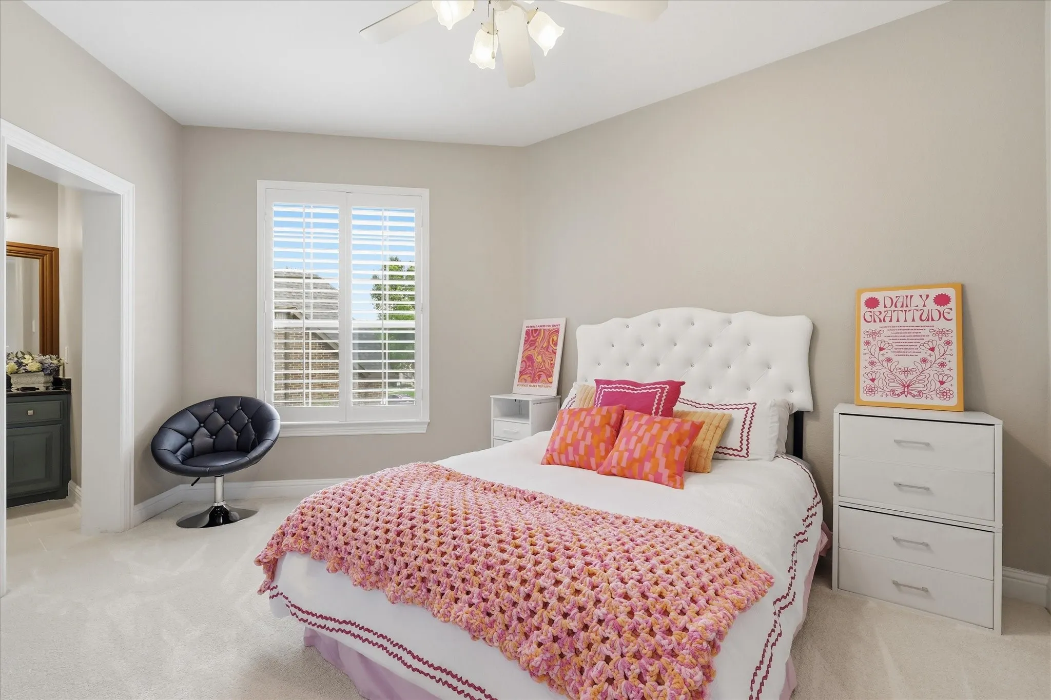 Bedroom featuring neutral wall paint, white trim, a white ceiling fan, and plush carpeting