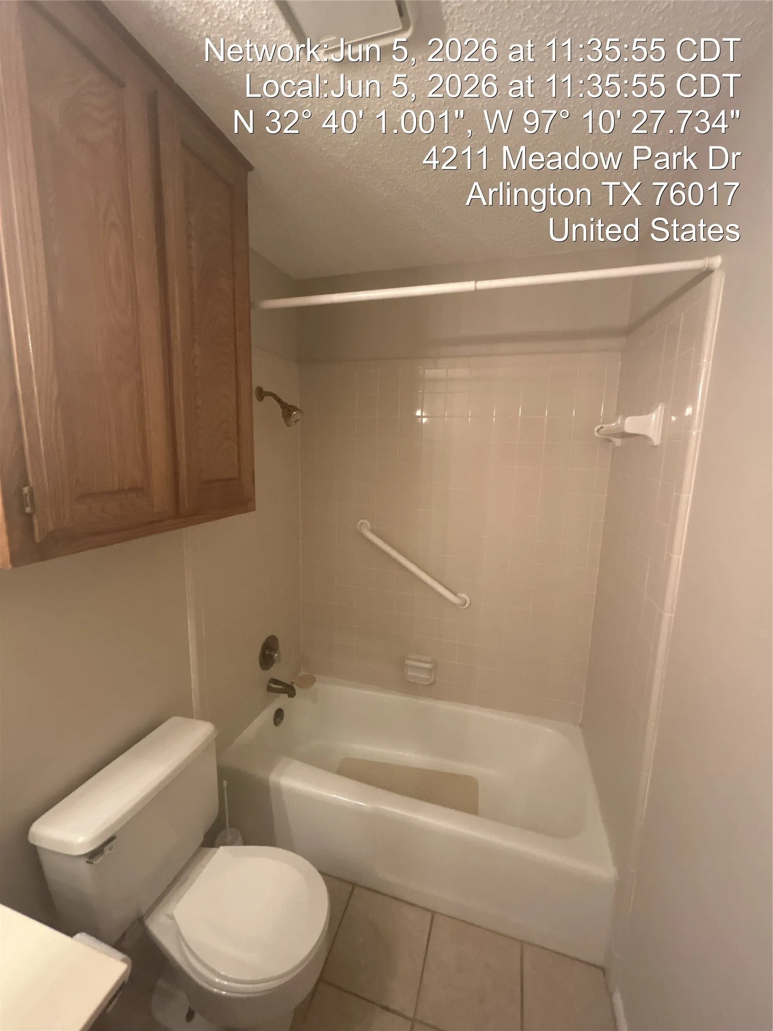 Bathroom featuring a white tub, shower with a curved shower rod, tile surround, and a grab​​‌​​​​‌​​‌‌​‌‌​​​‌‌​‌​‌​‌​​​‌​​ bar