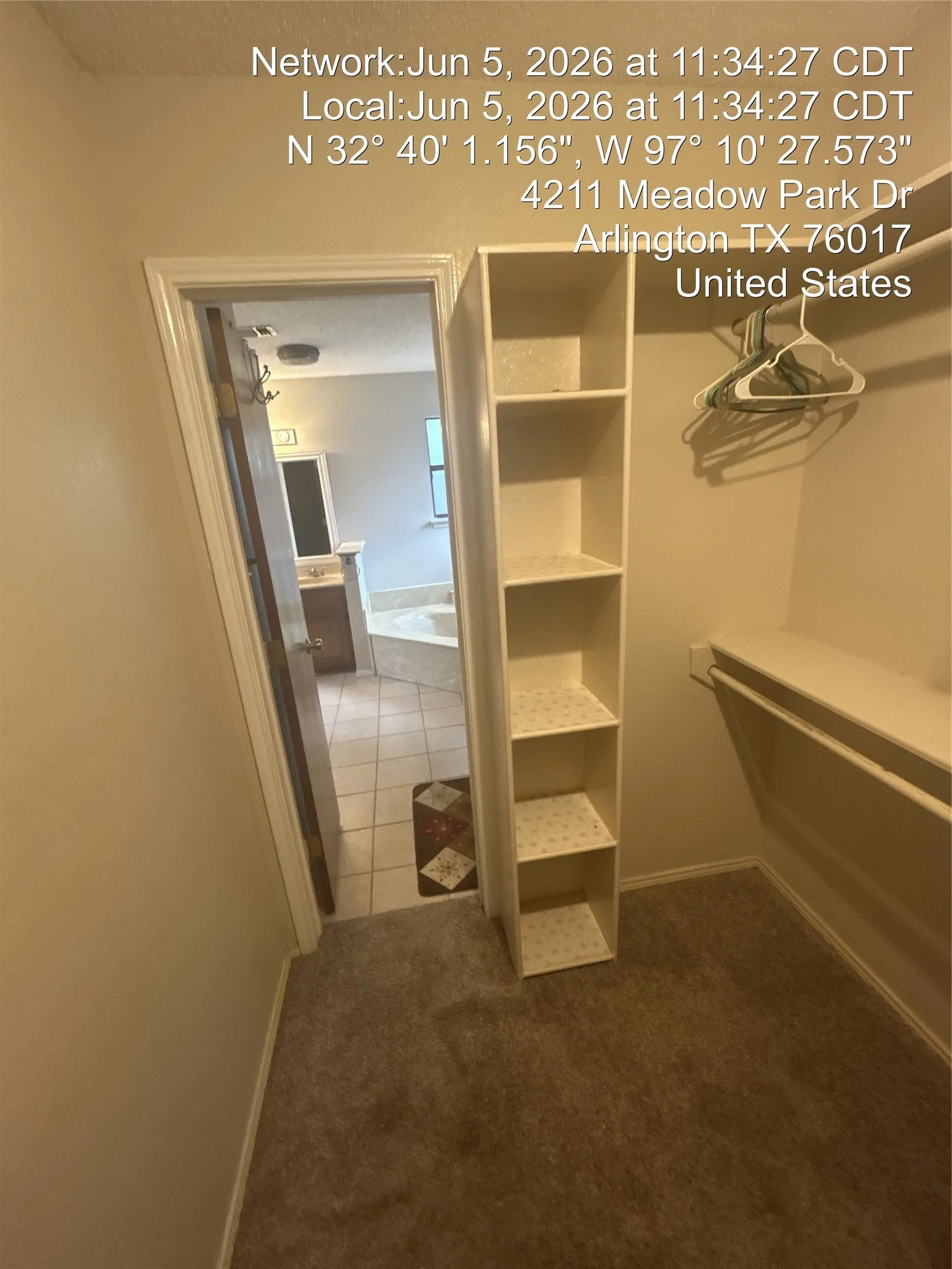 Walk-in closet with carpet flooring, built-in shelving, and clothes hanging rod