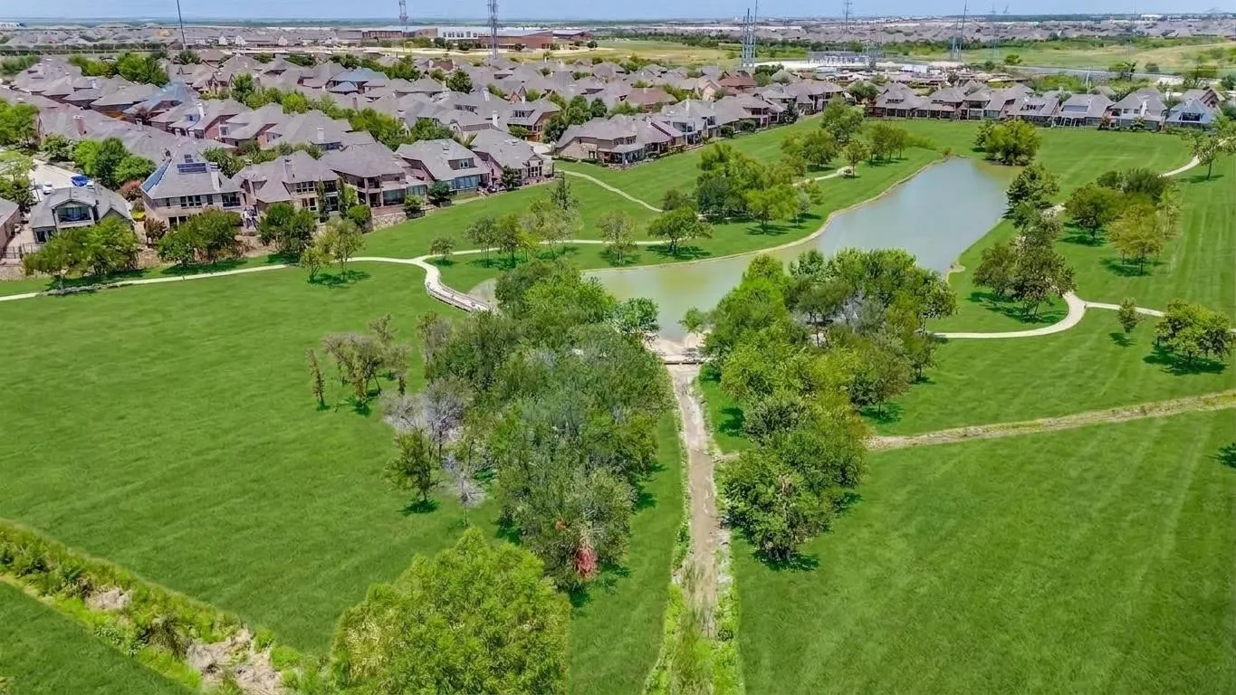 The pond is surrounded by a walking trail and has a picnic table. Often used by dog walkers
