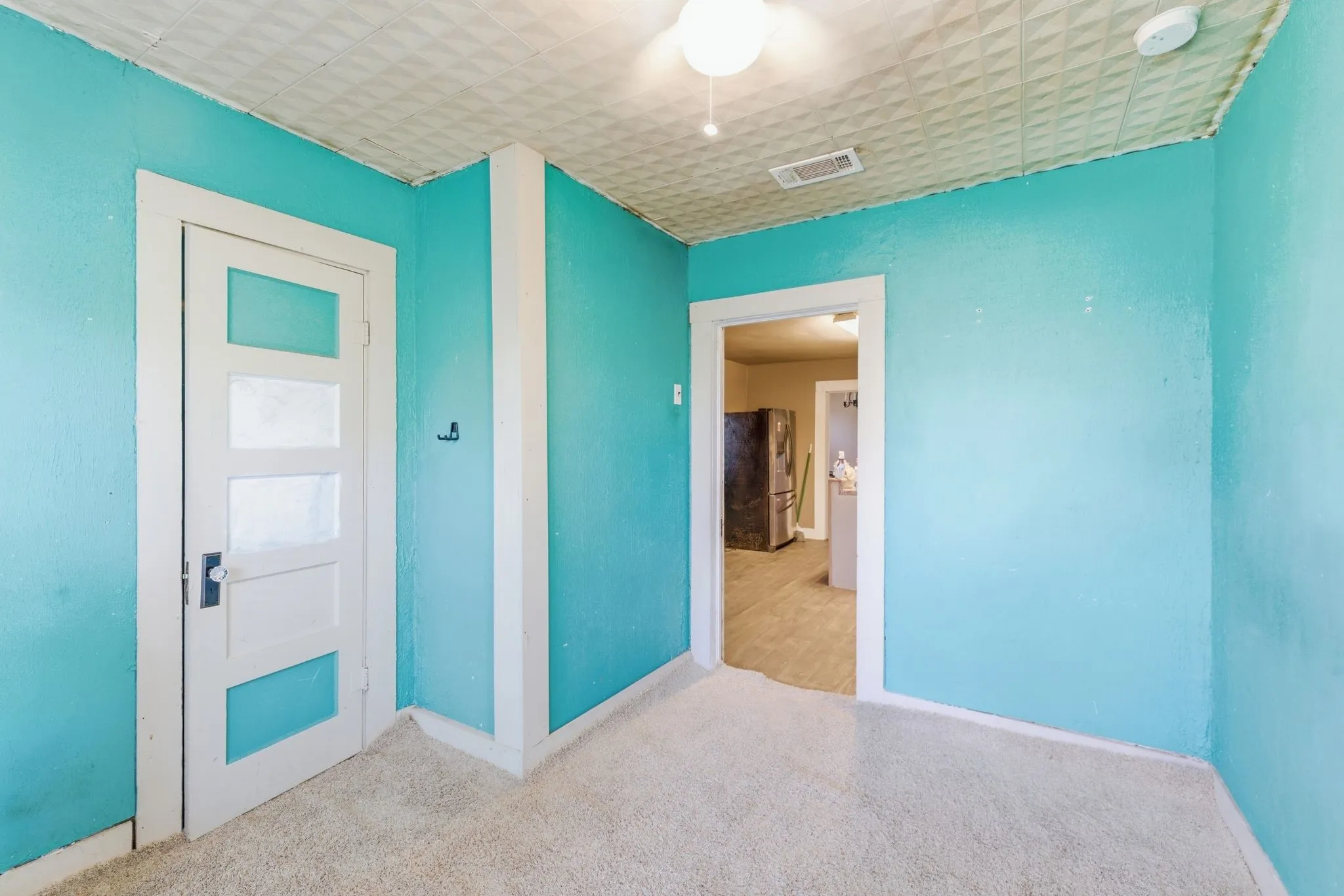 Room featuring light blue walls and a textured ceiling
