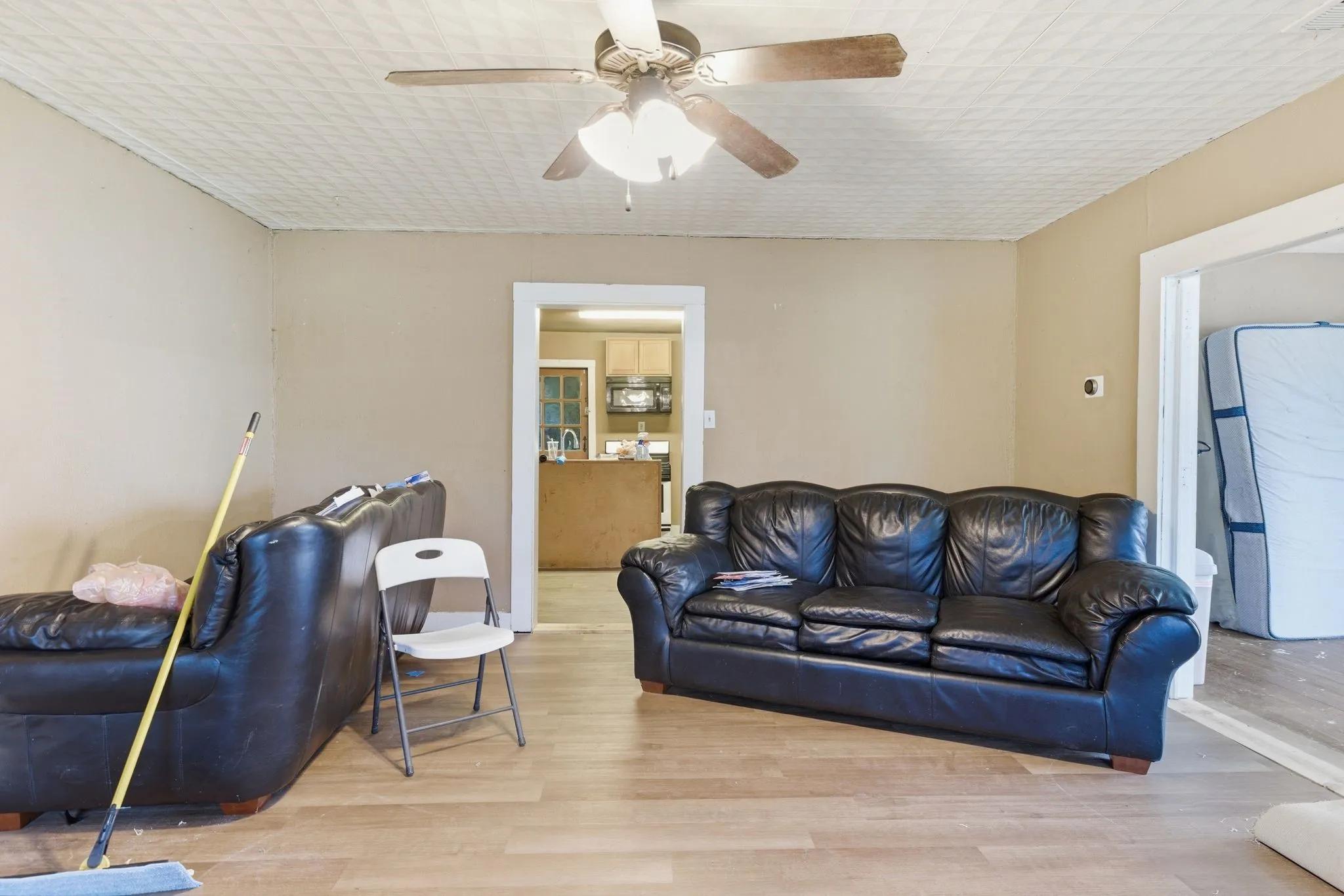 Living area featuring wood-finish flooring and a textured ceiling