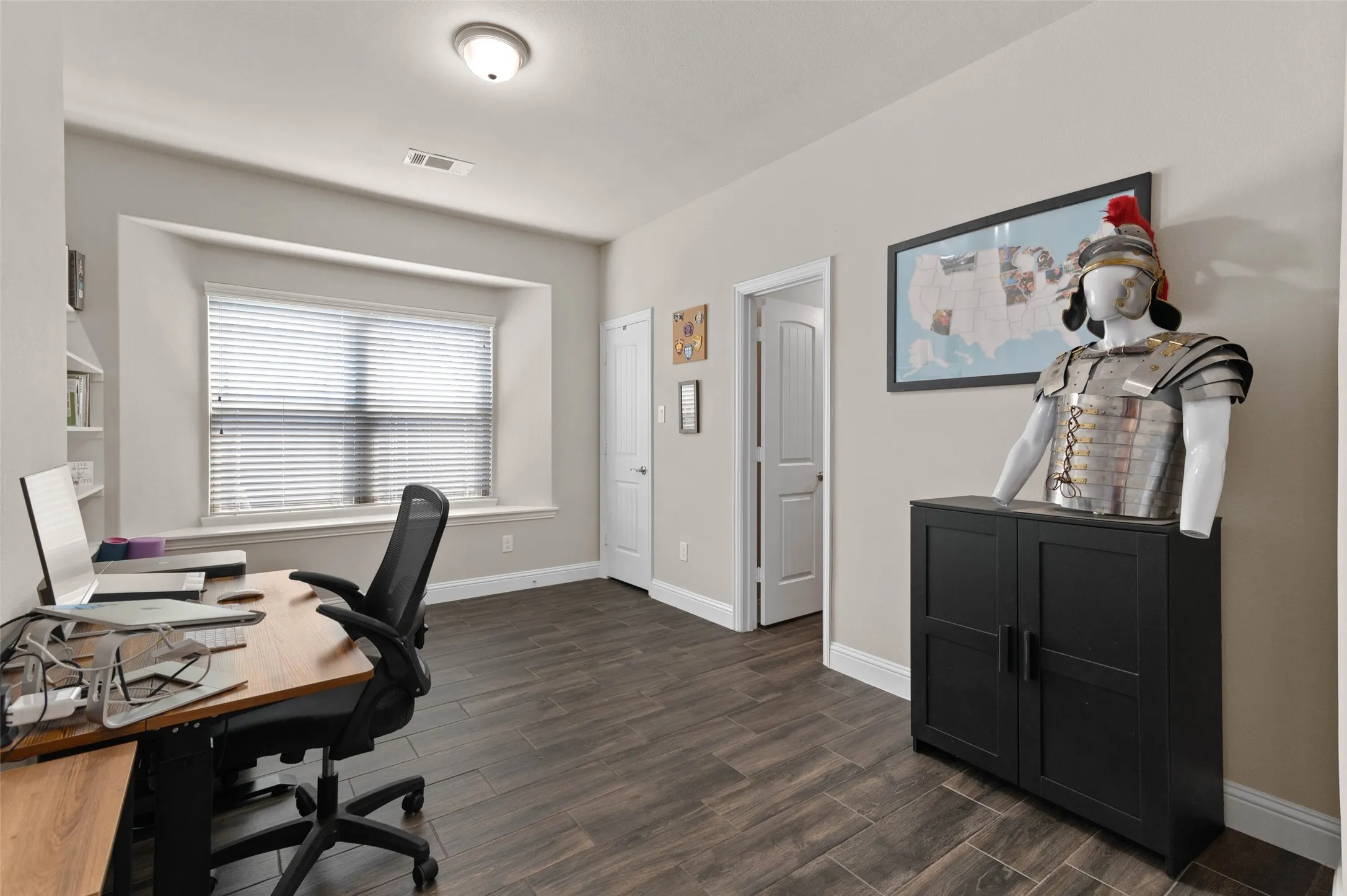 Bedroom used as an office! This room featuring wood-finish flooring, a recessed window, and white trim
