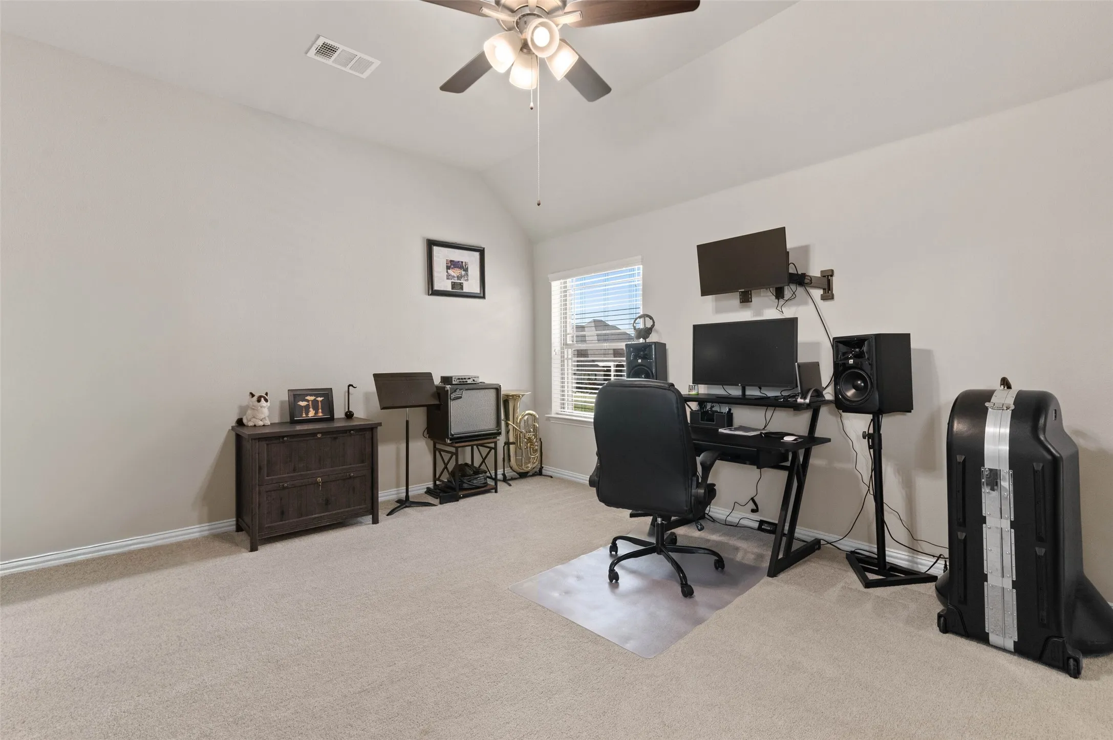 Spacious Secondary Bedroom room featuring vaulted ceilings, neutral wall paint, and light-toned carpet flooring