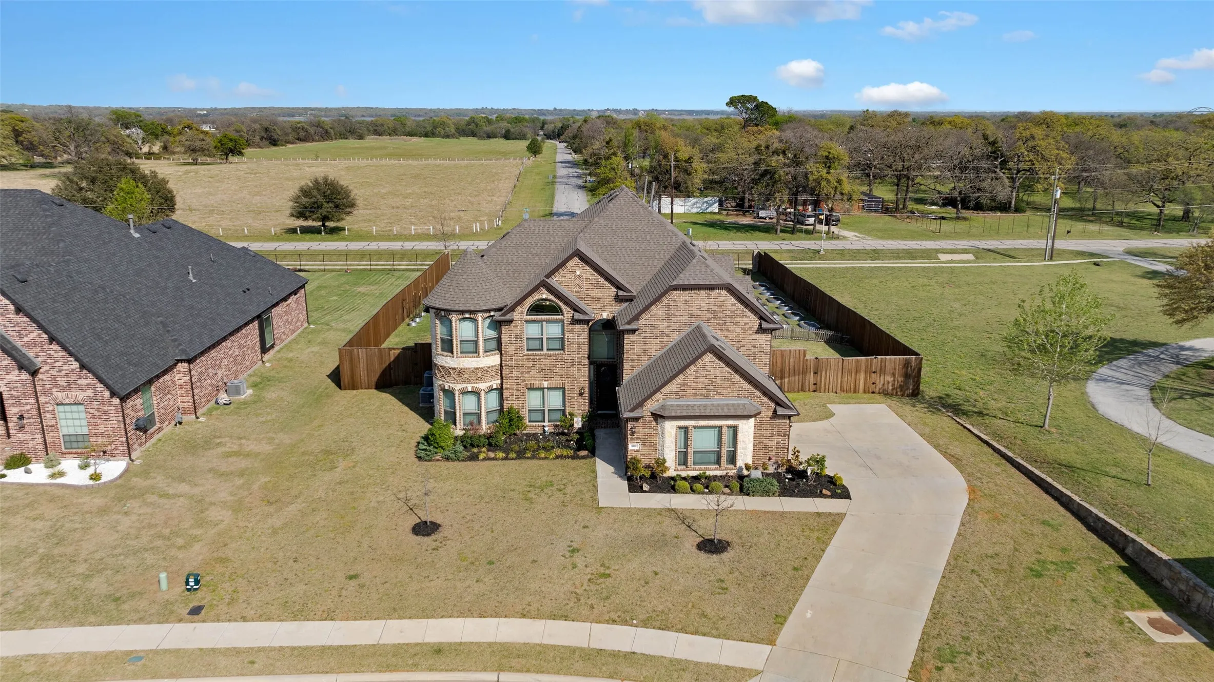 Aerial view of this amazing property! Brick exterior with stone accents and a multi-level roofline