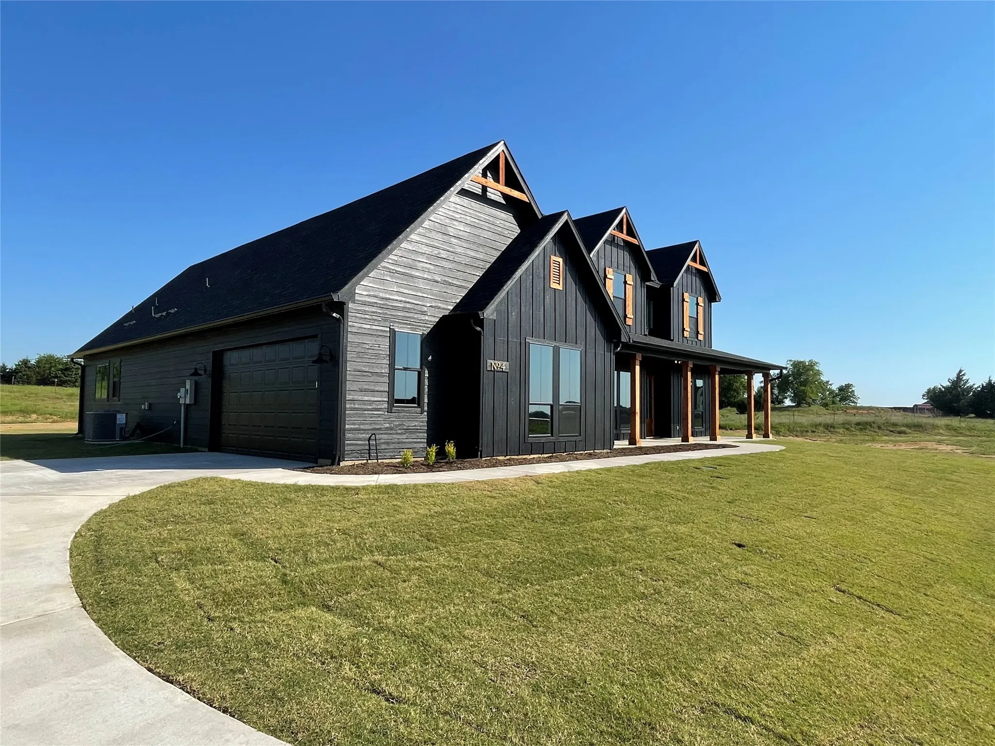 Modern farmhouse exterior with dark horizontal siding and vertical board and batten accents