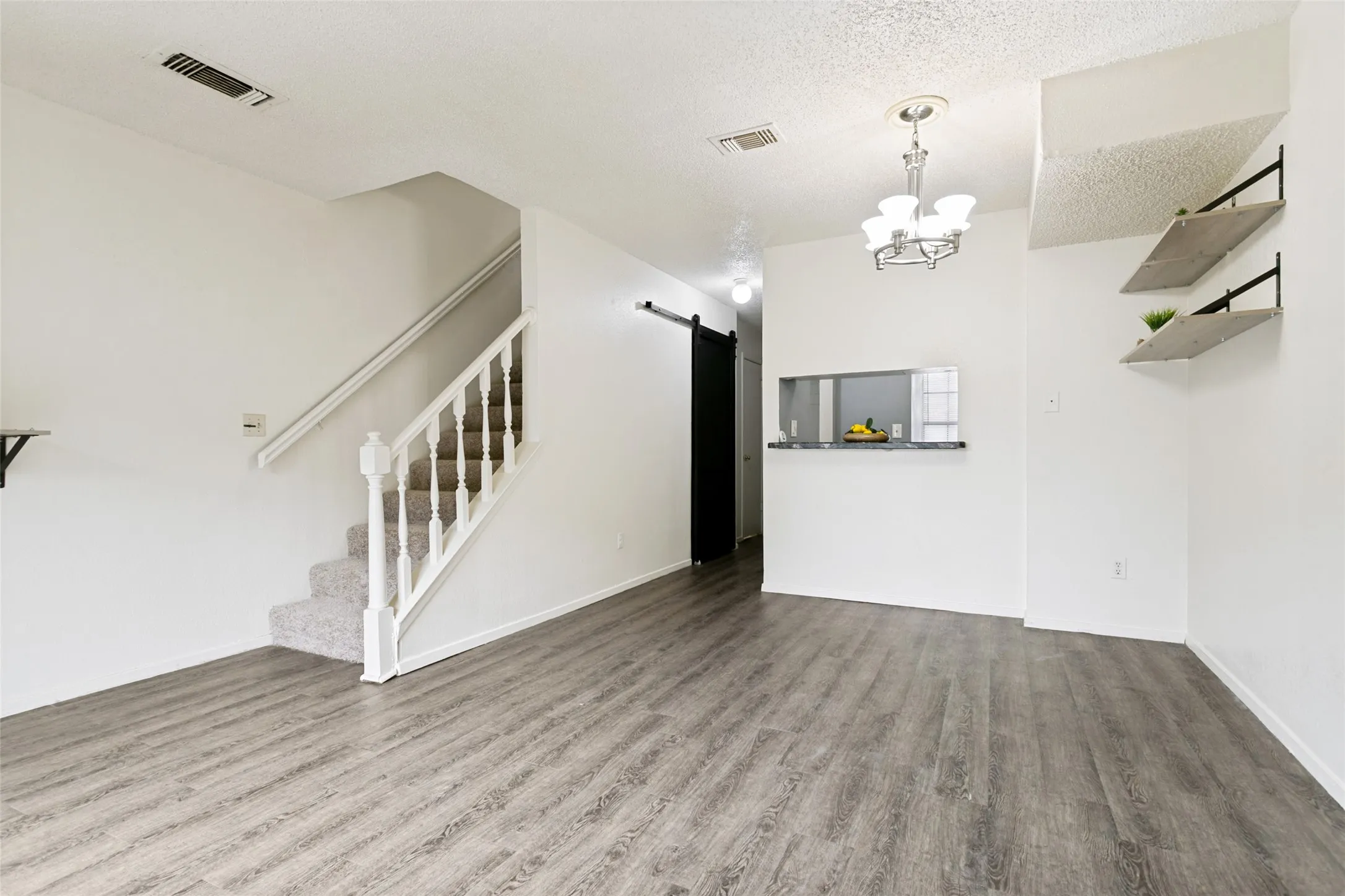 View of living room facing kitchen and front door