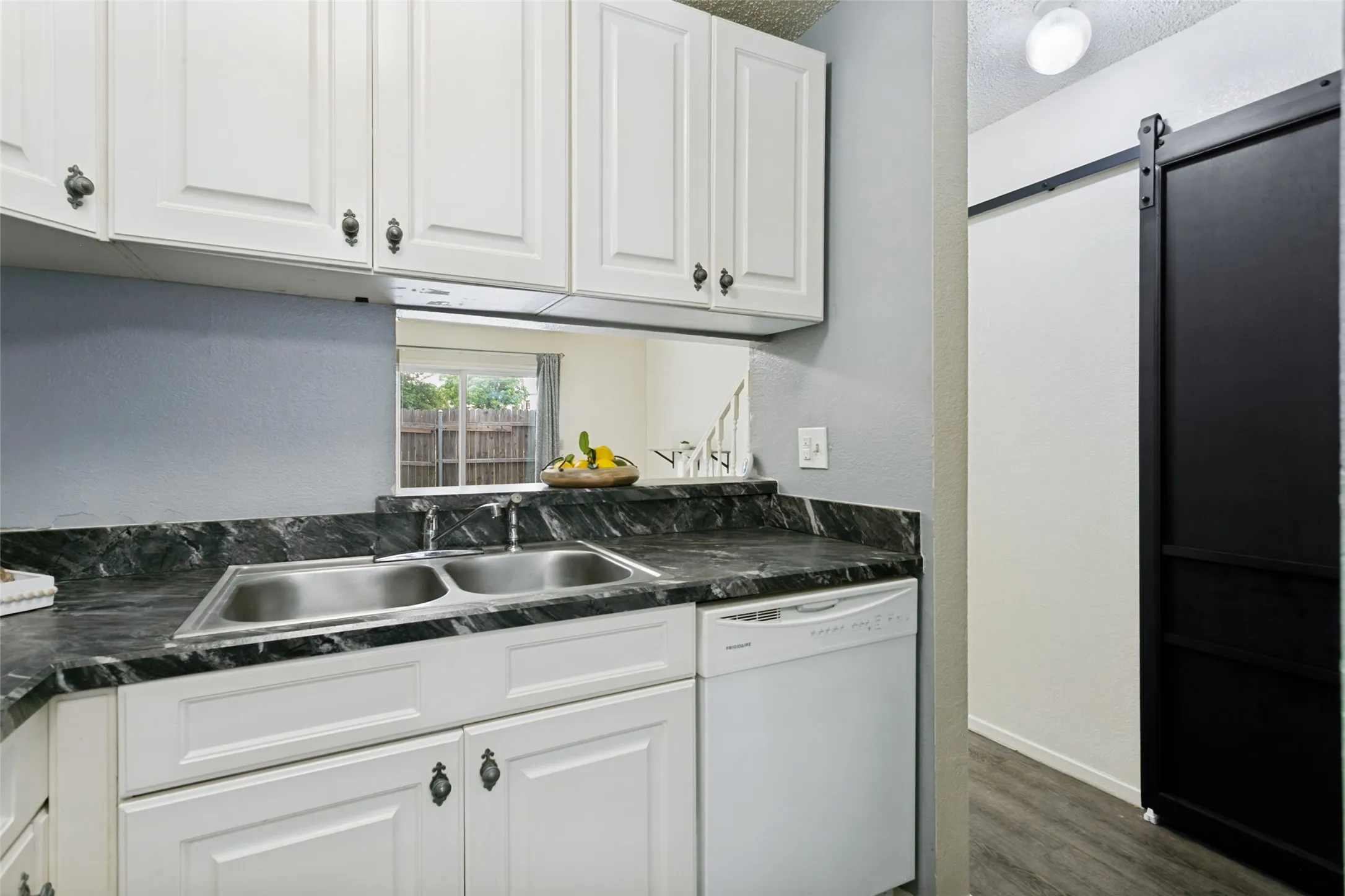 Kitchen facing living room and utility closet