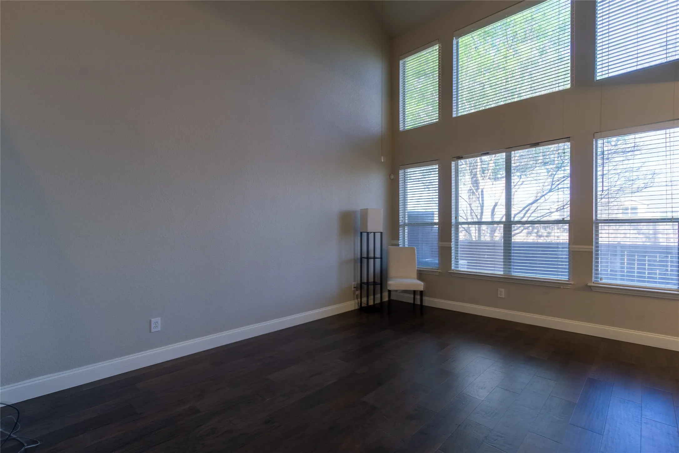 LIving room with high ceiling and large windows for natural light