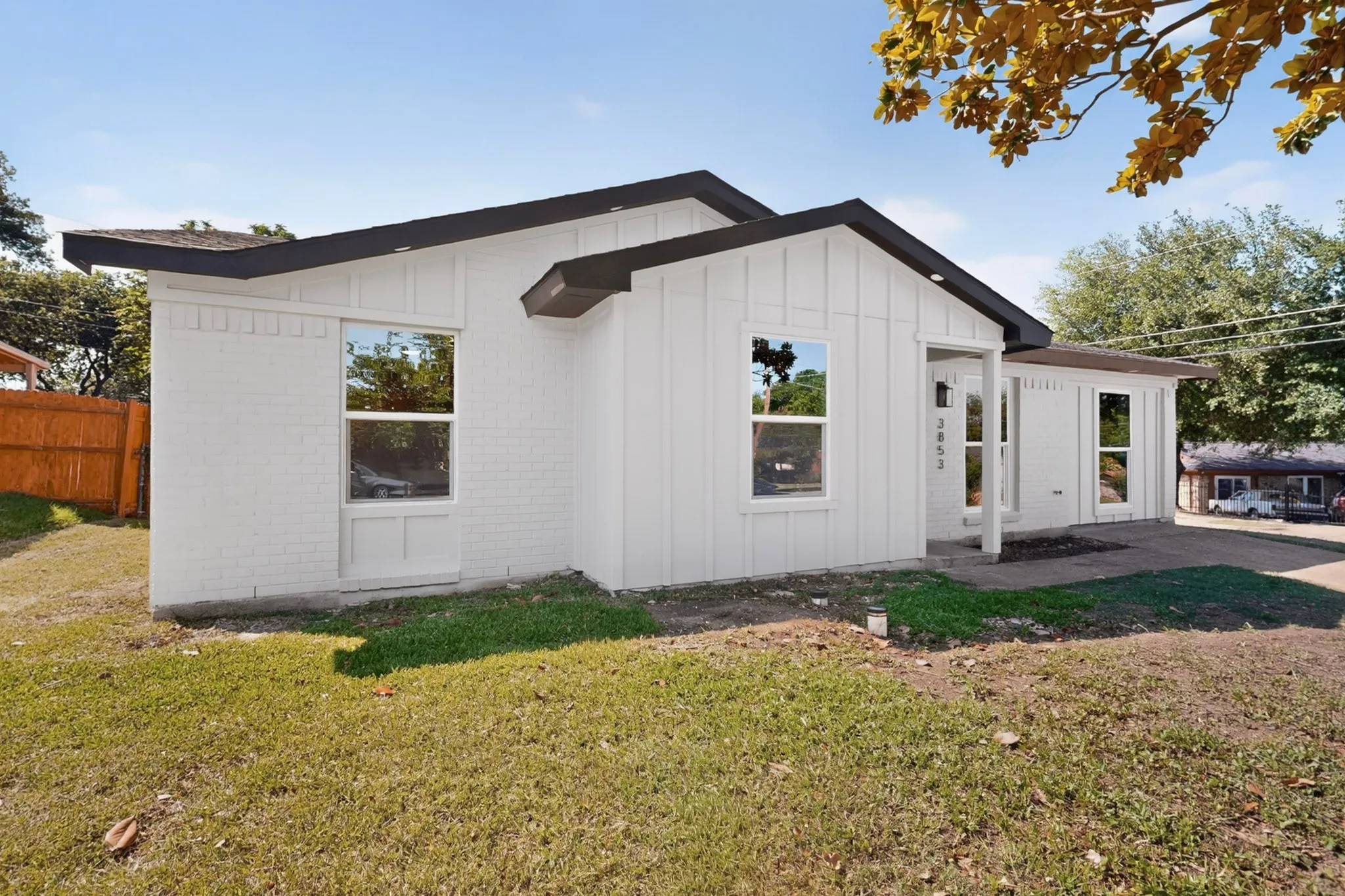 Crisp white exterior featuring board and batten siding and painted brick