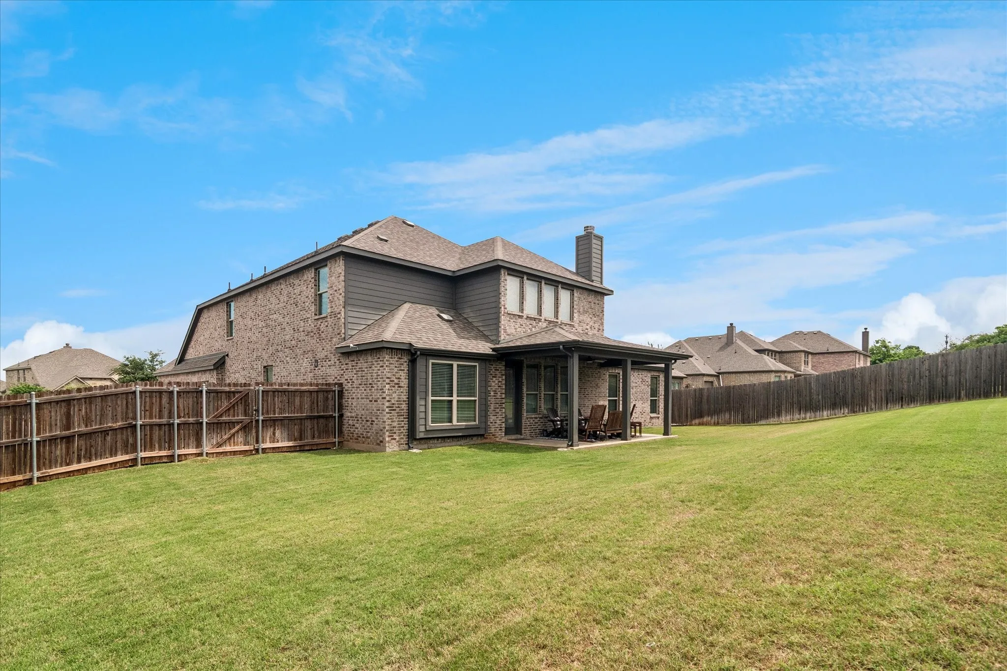 Expansive grassy yard with full privacy fencing