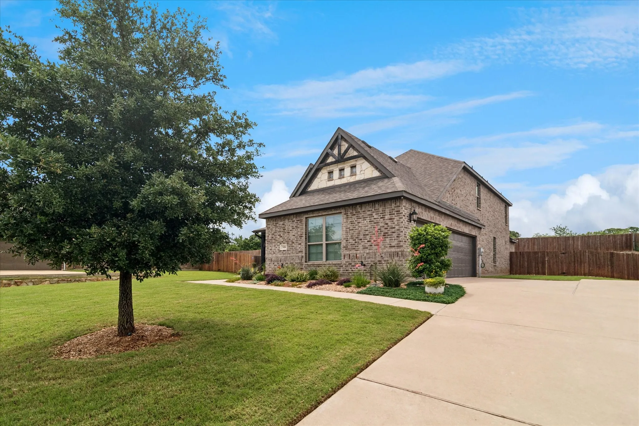 Brick facade residence featuring a prominent front gable with decorative timber accents