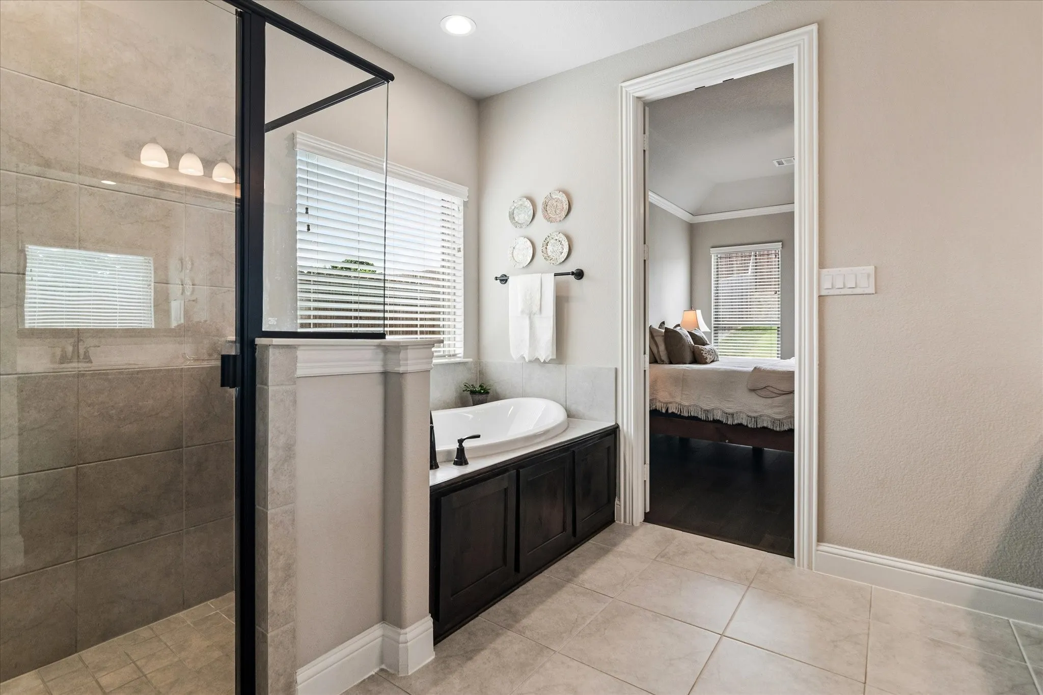 Contemporary bathroom featuring a walk-in shower with clear glass enclosure, a built-in soaking tub and tile floors