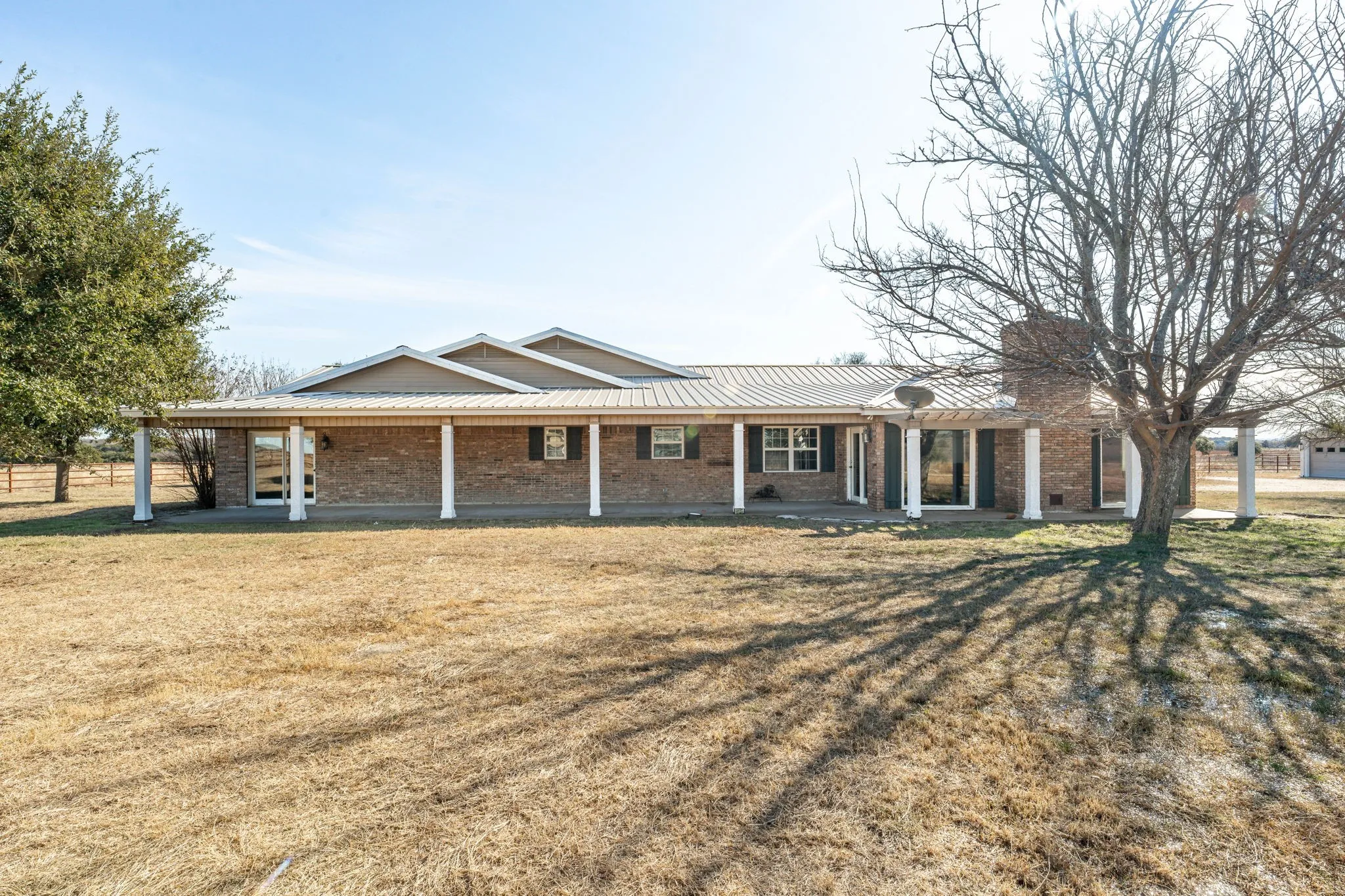 Brick exterior with a full-length covered porch supported by white columns