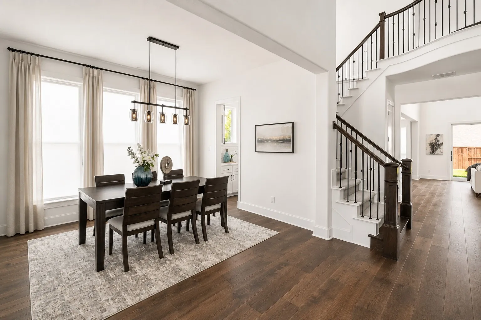 Formal dining area featuring a rectangular chandelier with clear glass shades