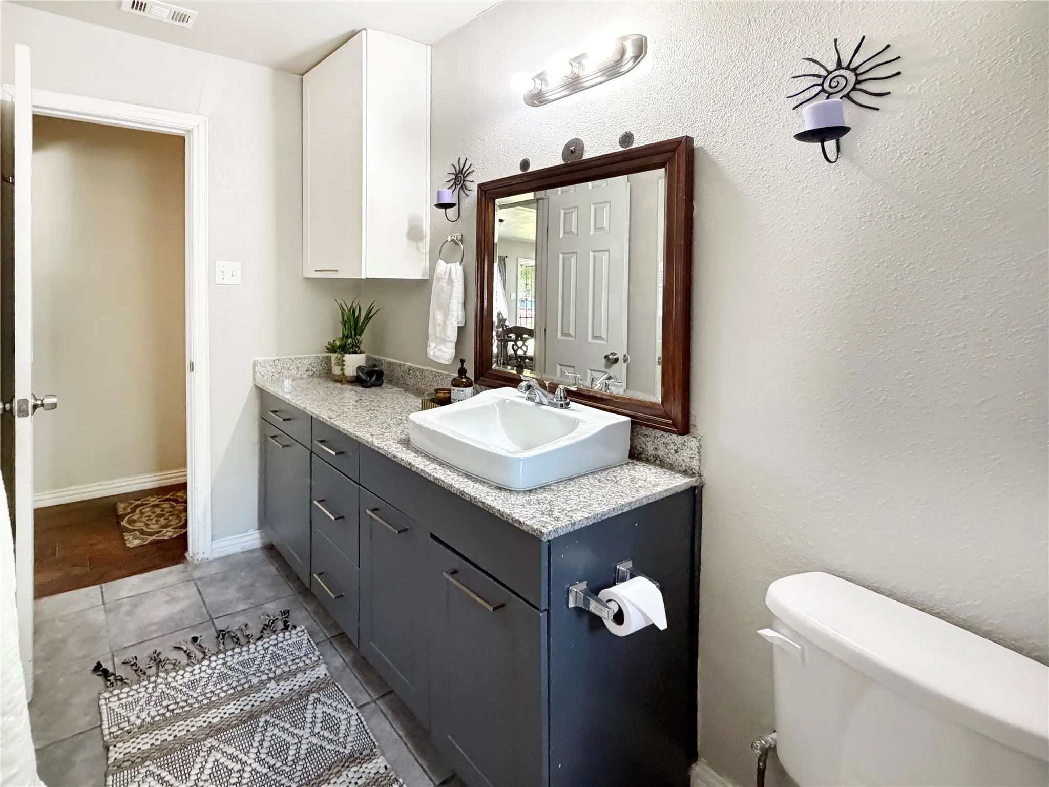 Bathroom 2 features updated cabinetry for ample storage.