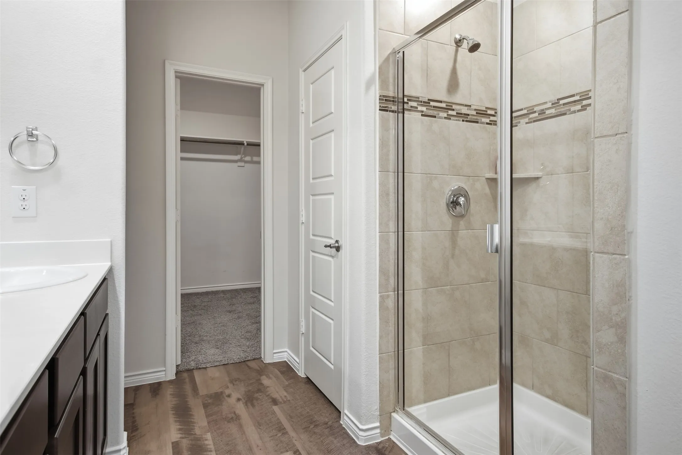 Walk-in shower with tiled surround and glass enclosure