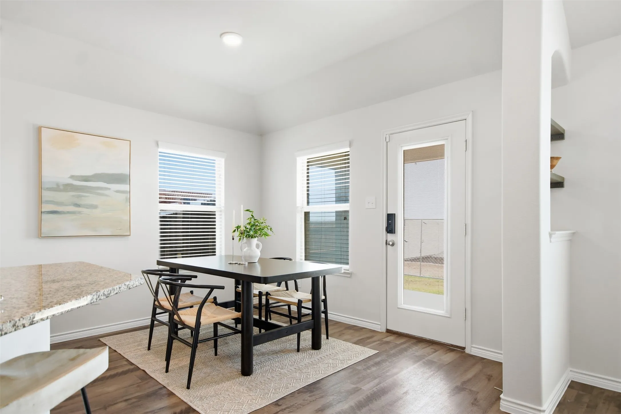 Recessed lighting, wood-finish flooring, two windows with blinds, built-in shelving, and a full-light door