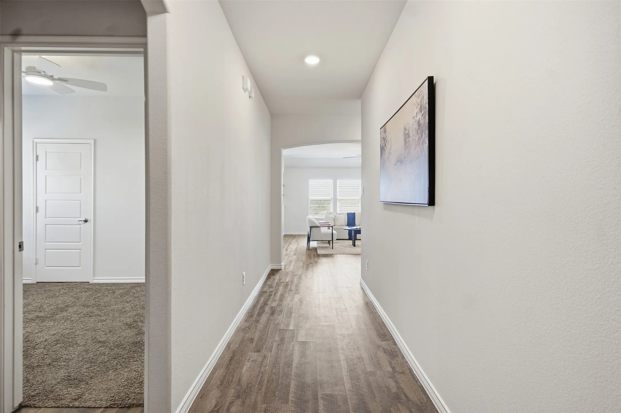 Foyer with wood-finish flooring, recessed lighting, and an arched doorway