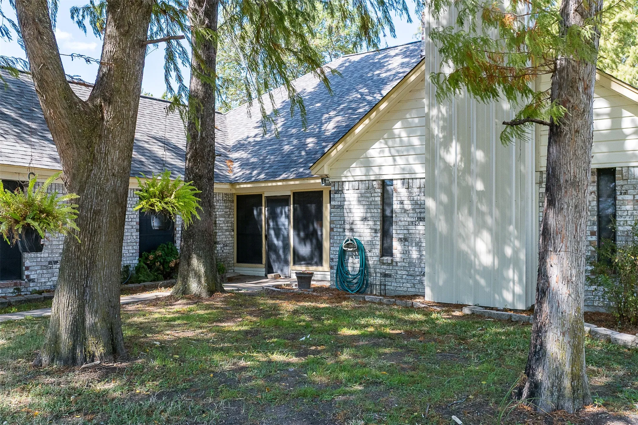 View of back of home with roof with shingles