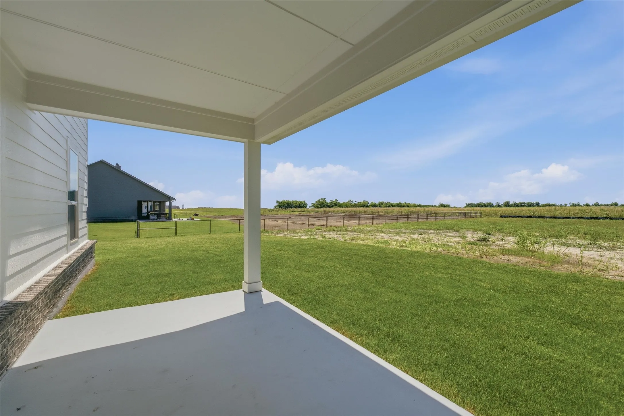 Covered patio featuring a concrete slab and white support columns