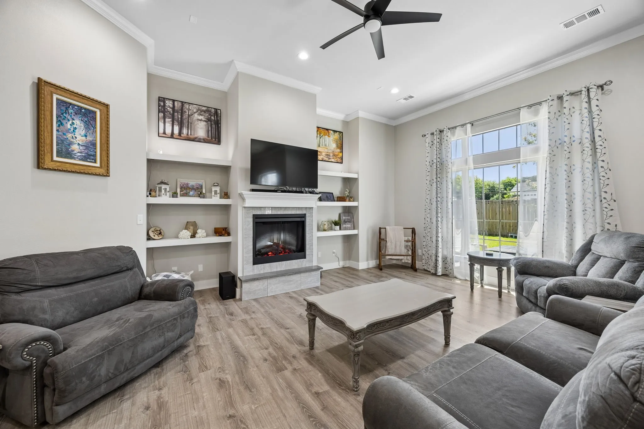 Living area featuring wood-finish flooring and crown molding