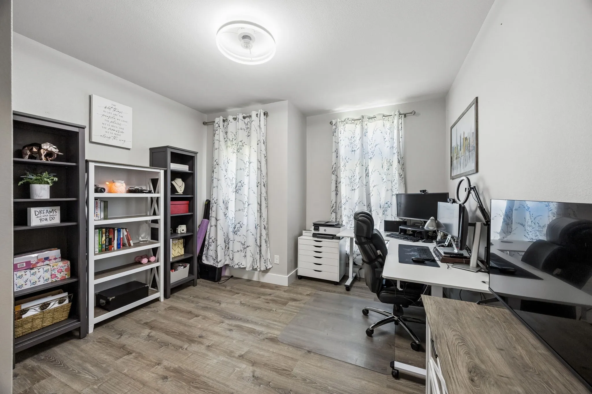 BedRoom featuring wood-finish flooring, two windows with drapery, a ceiling-mounted light fixture, and light-colored walls