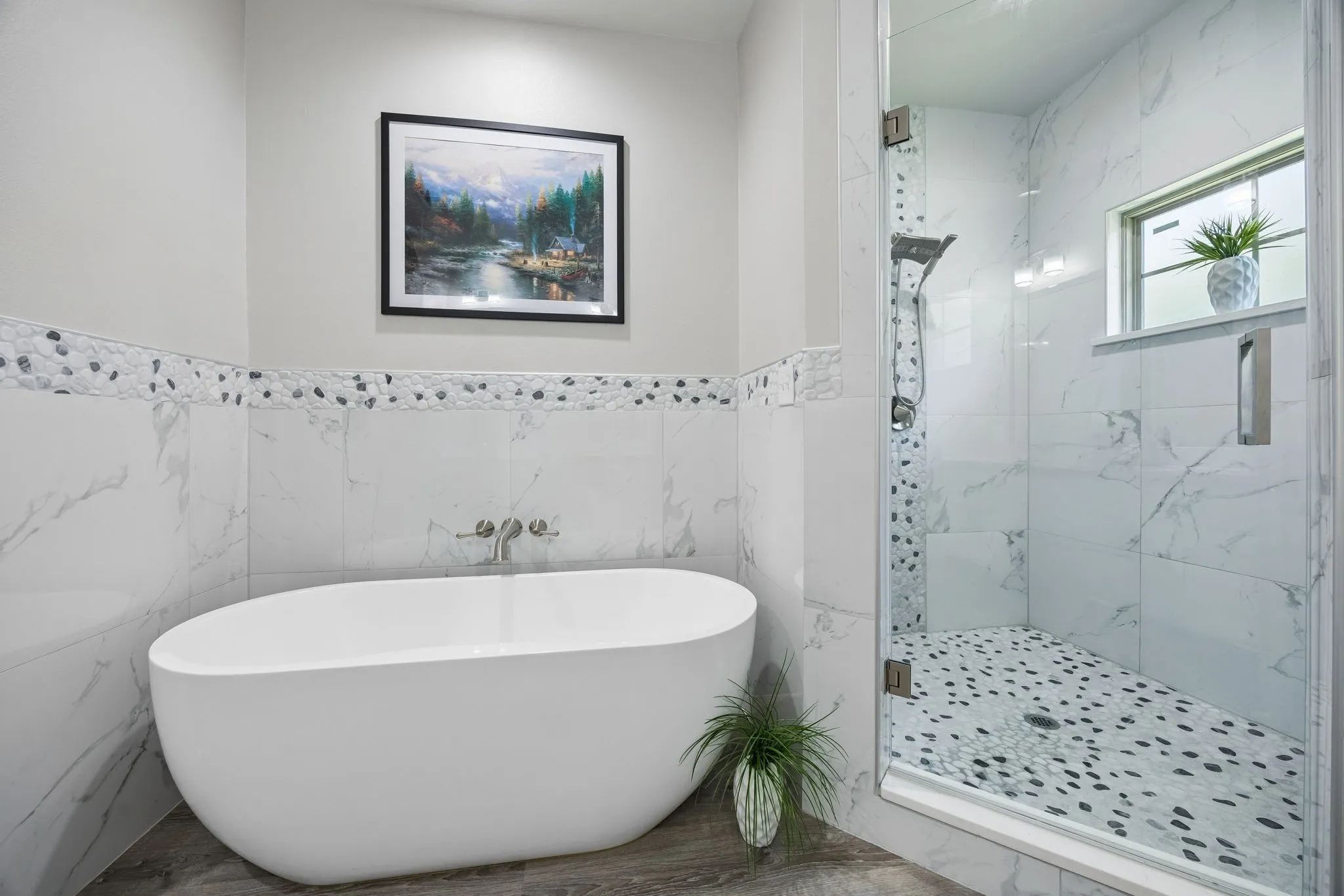 Freestanding soaking tub with wall-mounted fixtures