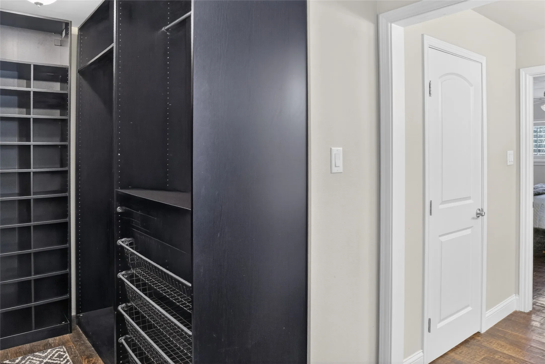 Primary custom-built closet. You will love the spacious closet with many built-ins to organize your close and shoes