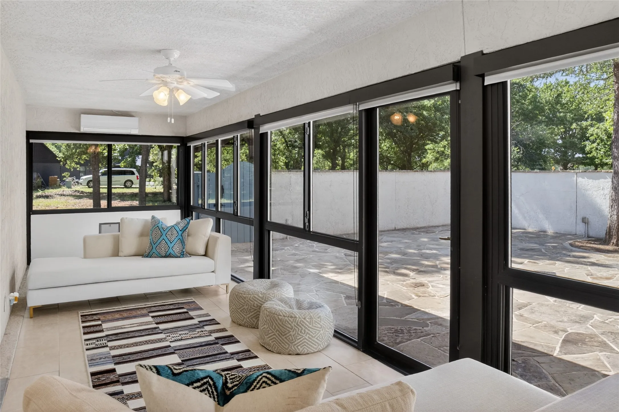 Covered sunroom with direct access from the living room that leads to patio/courtyard area.