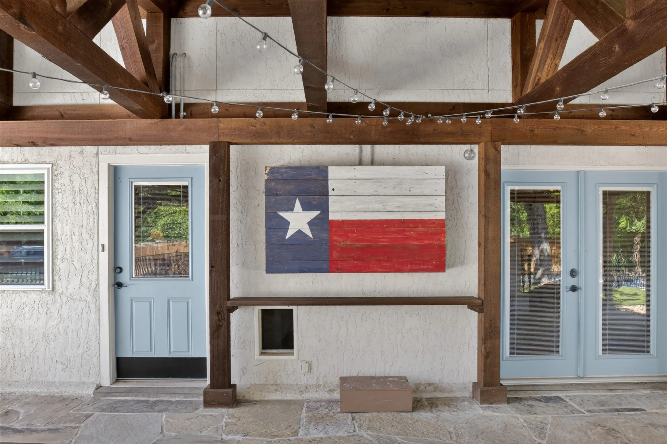 Another view of the outdoor living area looking back from the fireplace into the kitchen or secondary bedroom area/flex room. The Texas flag is a box that can accommodate a large TV, which keeps it protected from the weather