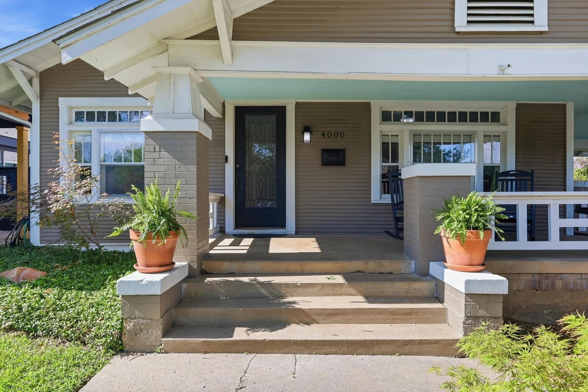 Welcoming covered front porch leading to a bright and inviting entryway.