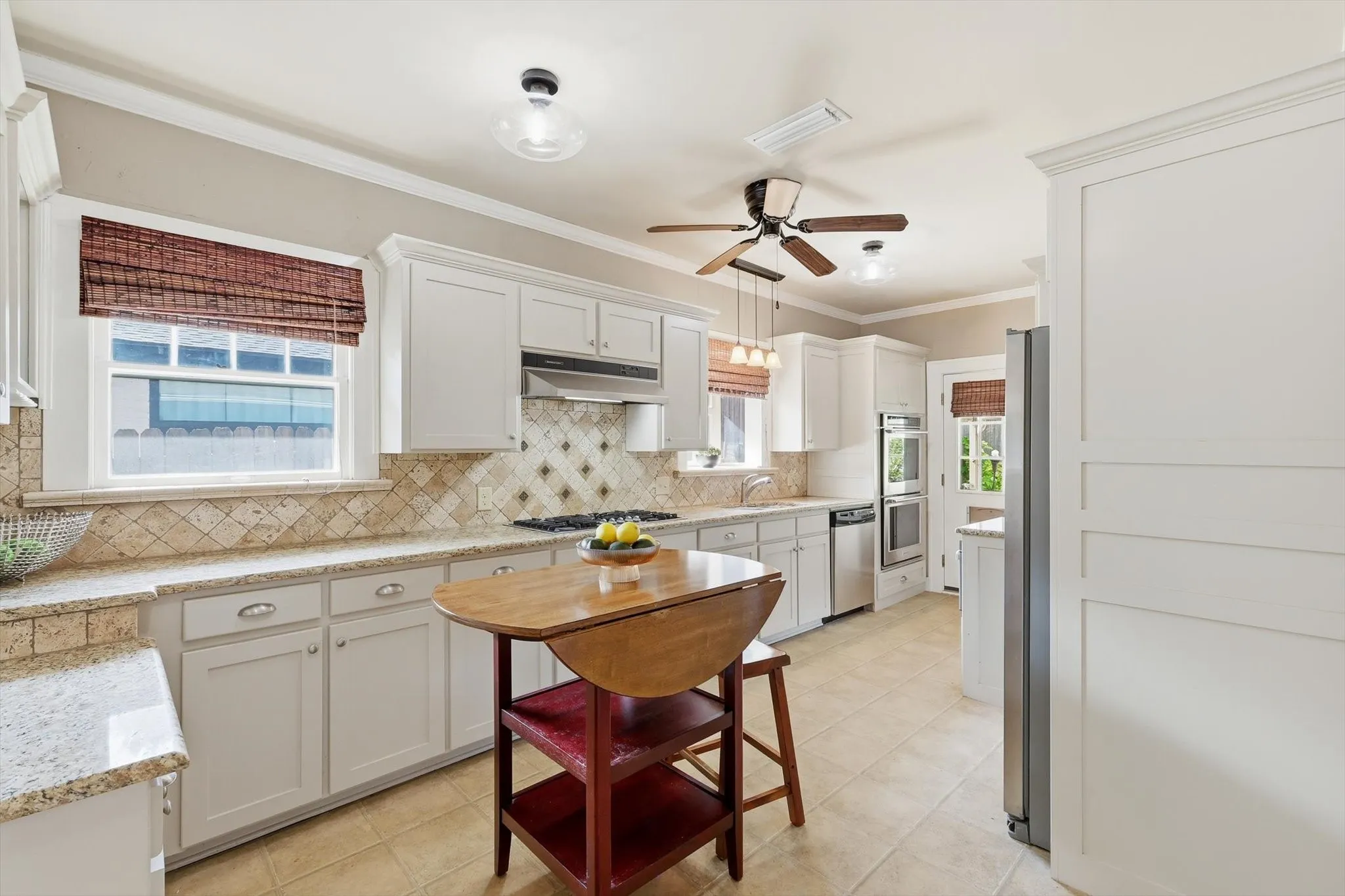 Updated kitchen featuring white cabinetry, ample counter space, and a functional layout.