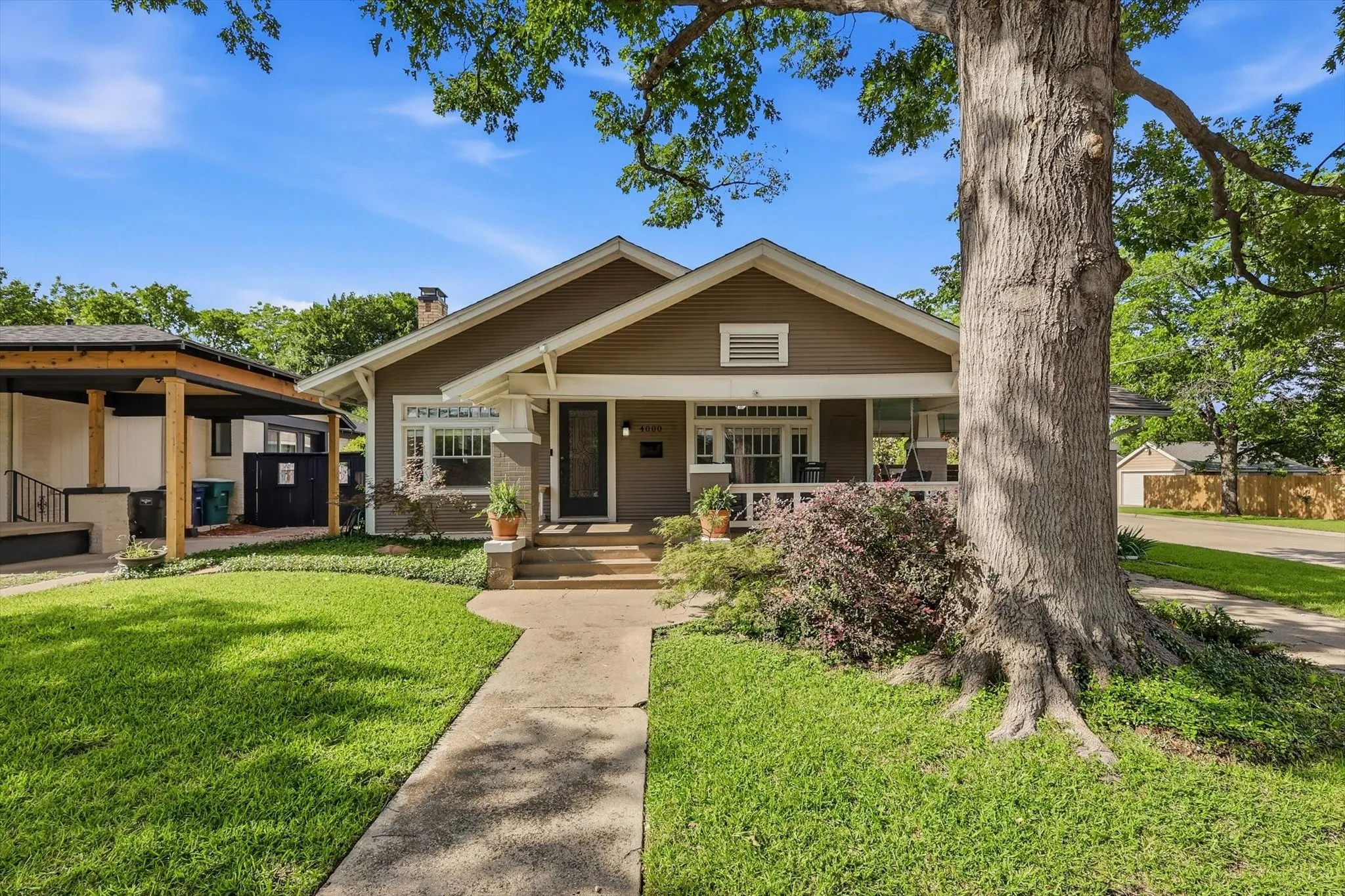 Beautiful exterior showcasing a welcoming front porch and lush landscaping.