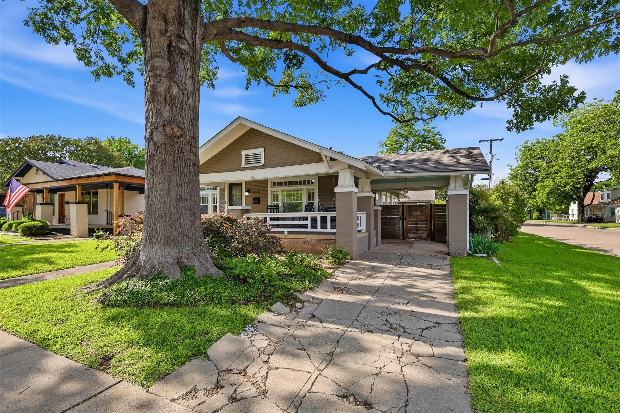 Spacious front yard with established shade trees and attractive home façade.