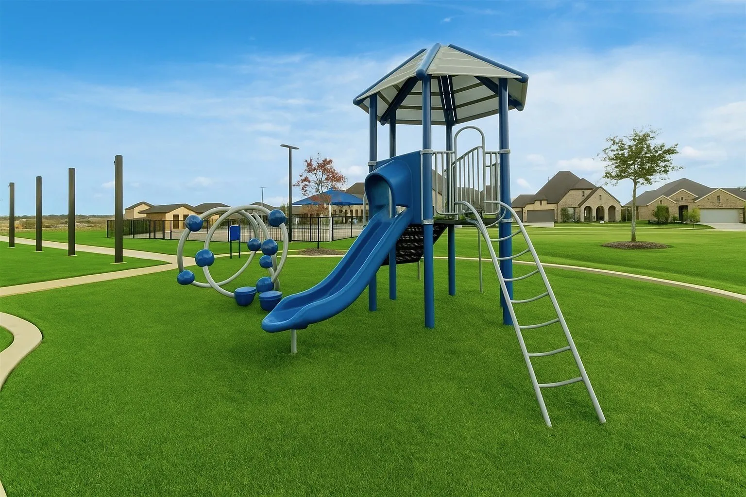 Communal playground featuring a yard and a residential view
