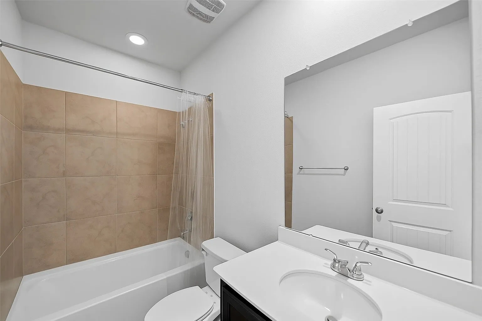 Bathroom with shower / bath combination with curtain, vanity, and recessed lighting