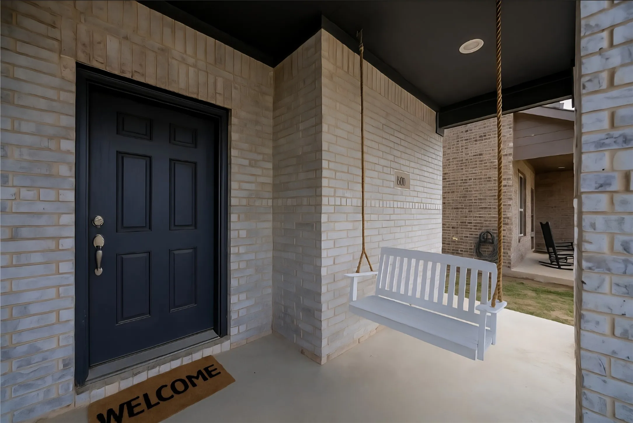 Entrance to property featuring brick siding