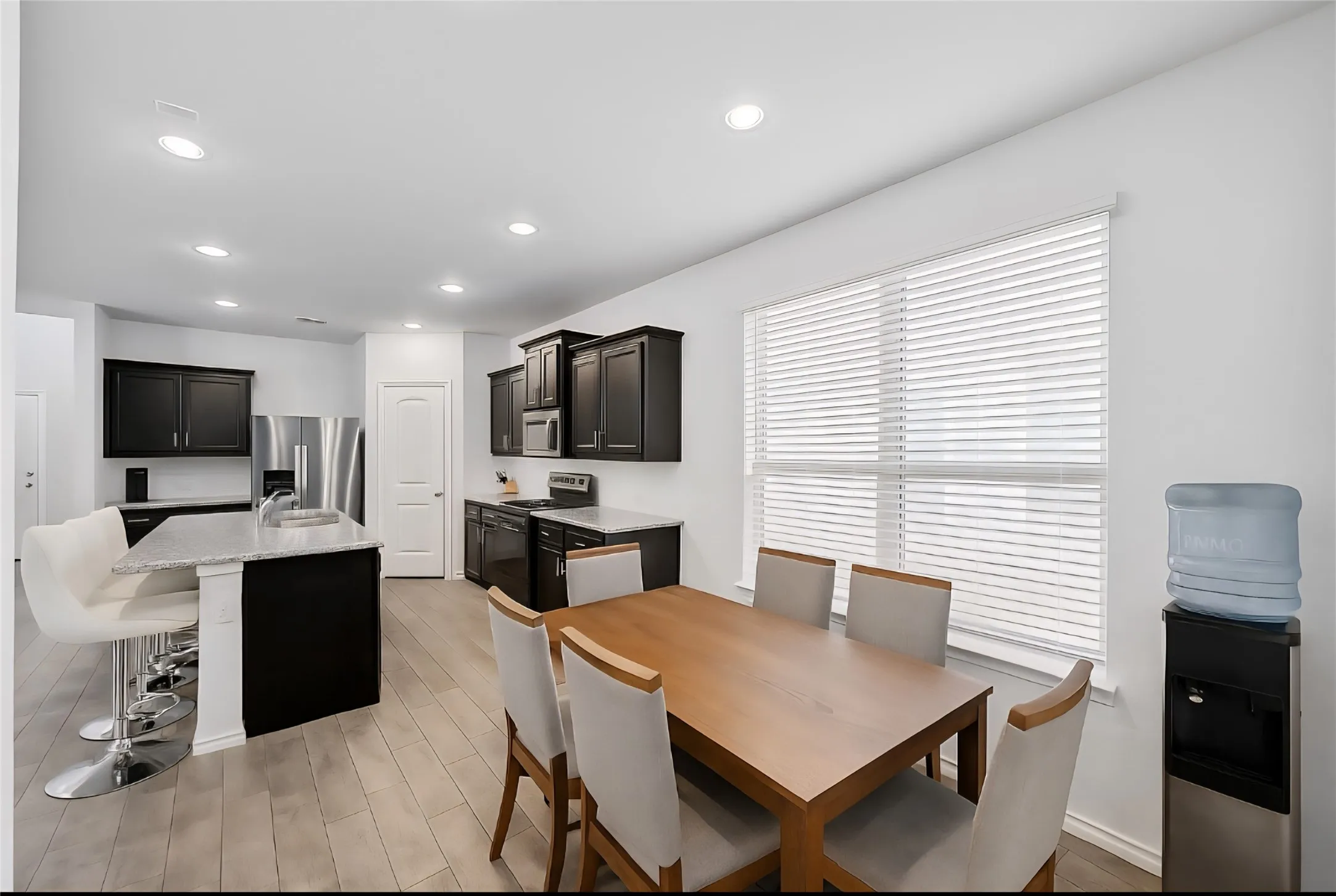 Dining room featuring light wood-type flooring and recessed lighting